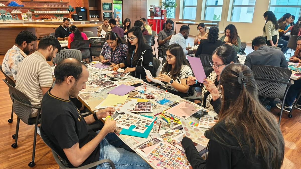 Colleagues cutting and collaging at a workshop