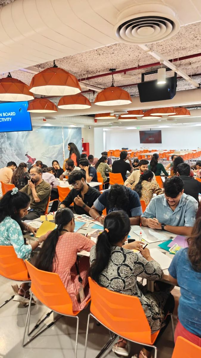 A large office team at a vision board activity